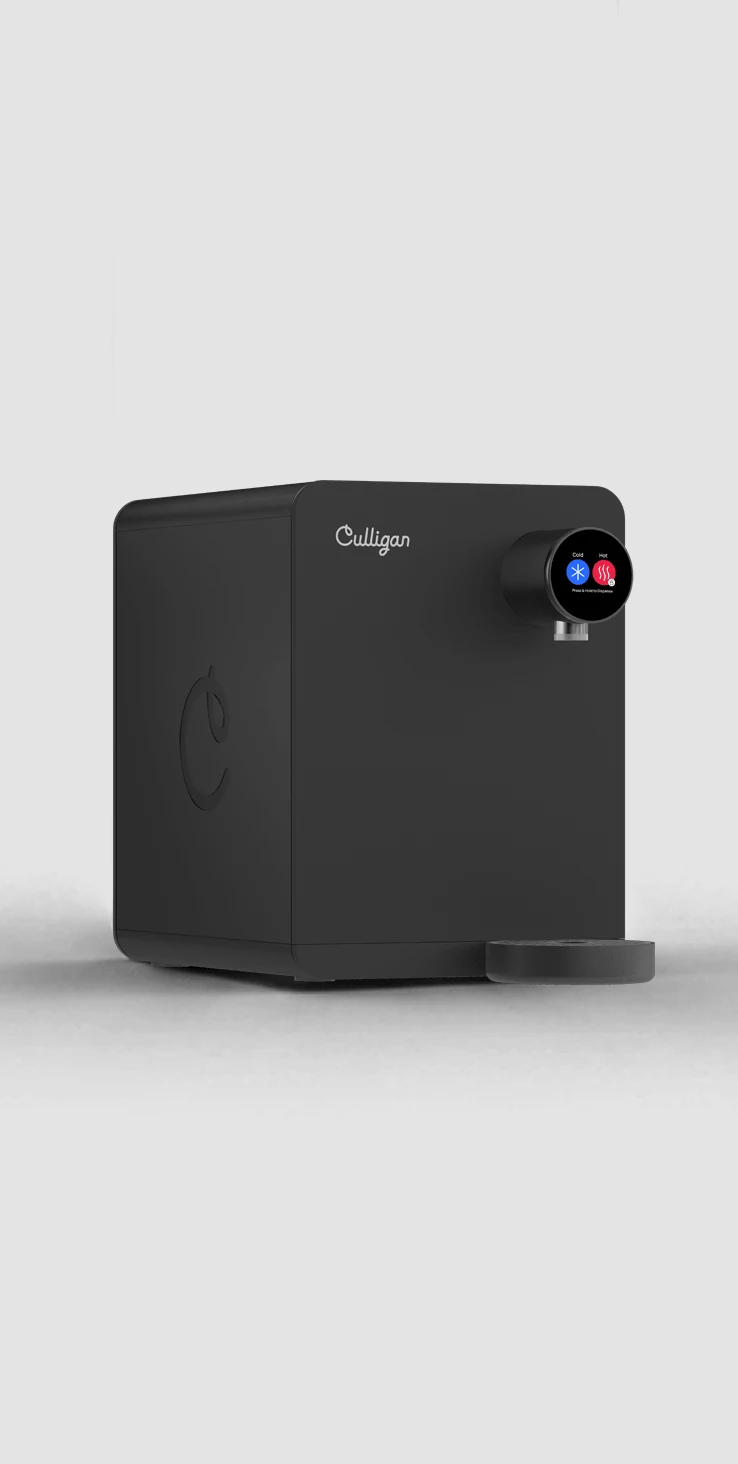 The Purity Essential countertop unit, a compact black dispenser standing on its own base.