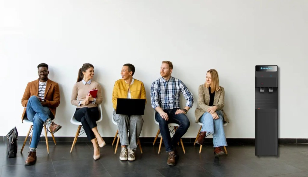 employees laughing with each other siting in chairs