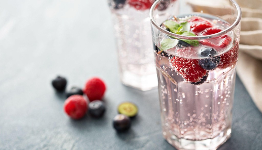 glass of sparkling water with fruit