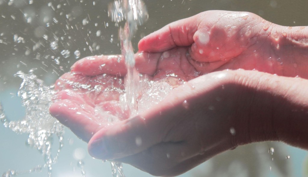 hands cupping flowing water