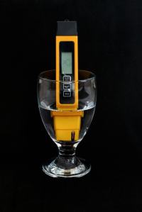 TDS meter in glass of water