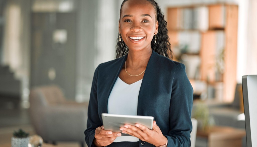 professional woman smiling holding tablet