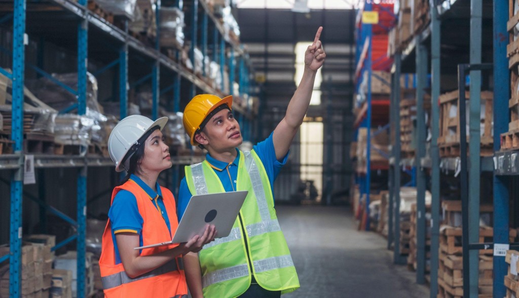 warehouse workers talking and pointing