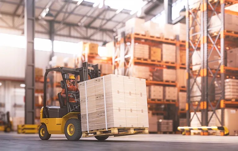 inside a warehouse with warehouse shelves and cherry picker machine