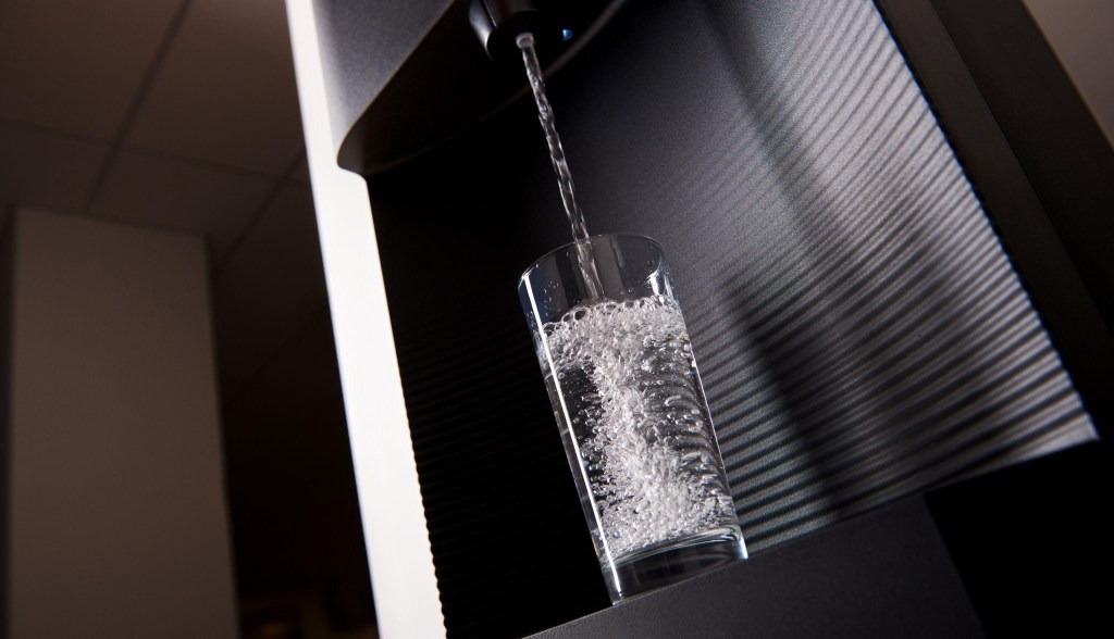 bottleless water cooler filling up glass of water