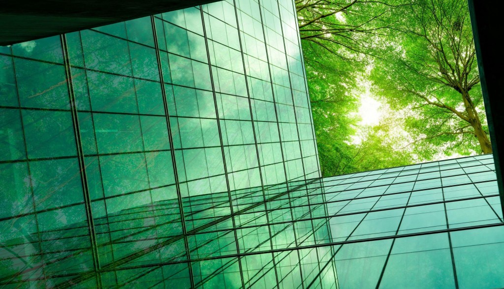 green glass building with trees