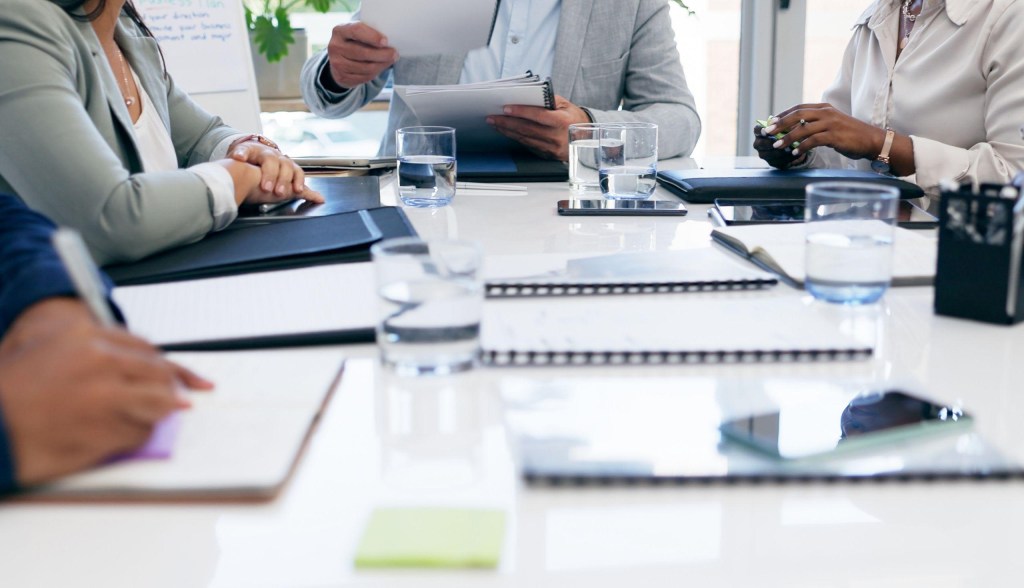 professionals in a meeting with glasses of water