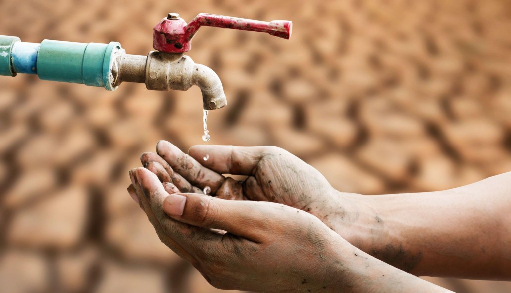 hands getting water from water spout