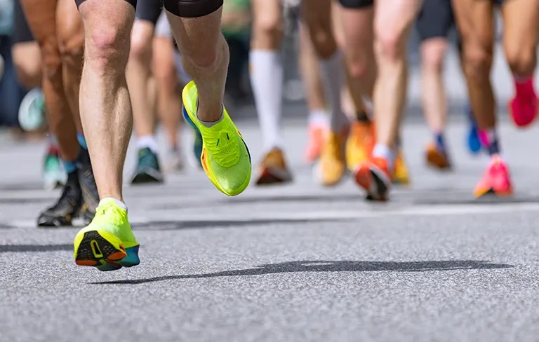 street runners running a race only sneakers and legs showing