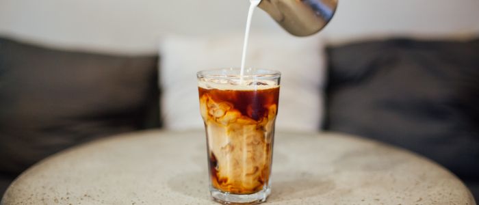 Creamer being poured into coffee