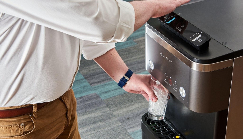 man getting water from bottleless water cooler