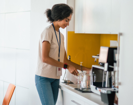 woman making coffee in breakroom