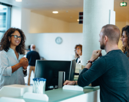 man and woman talking at computer