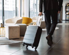 man rolling suitcase