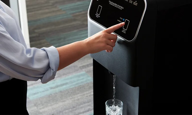 woman dispensing a touchless water cooler