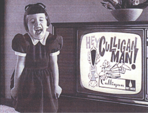 Black and white photo of a girl in front of a Culligan commercial