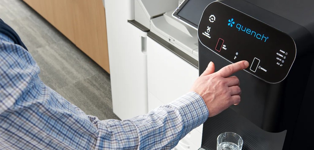 Man dispensing touchless bottleless water cooler