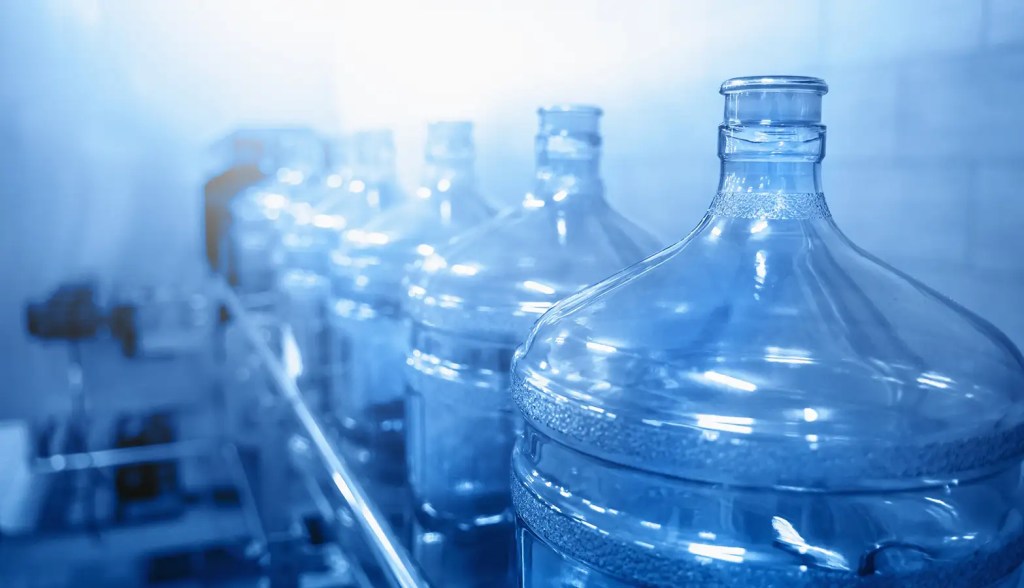 empty water jugs with blue background