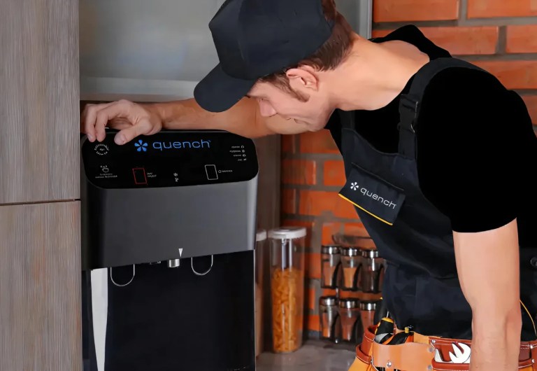 Service man standing over Quench machine