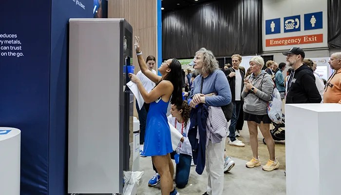 Man raising up an aluminum bottle of Culligan water