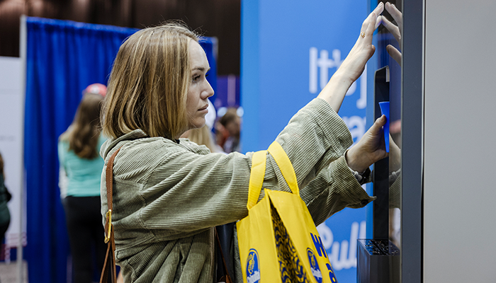 Woman dispensing Twist flavored water dispenser