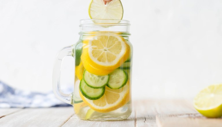lemon lime water in a glass placed on a table