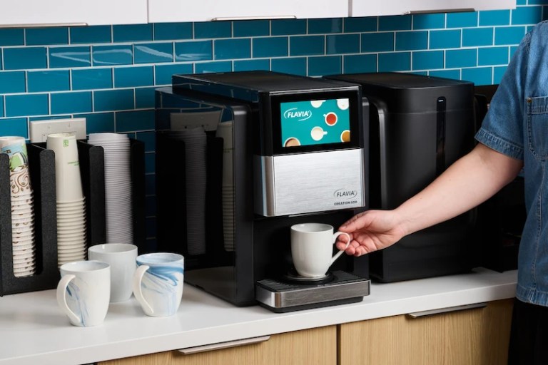 144 Commercial Single-Cup Brewer on countertop with coffee mugs