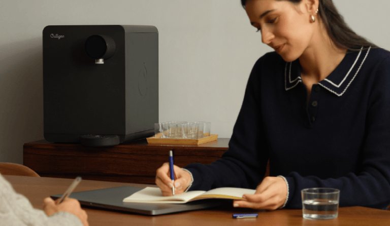 Woman writing in notepad with Purity Countertop in background on table